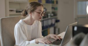 teacher at desk - corporate chair massage maryland - Corporate Massage Kneads